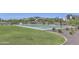 Outdoor basketball court with lush green grass and well-maintained landscaping surrounding the court at 17140 W Running Deer Trl, Surprise, AZ 85387