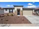 Charming single-story home with stone accents, well-maintained landscaping, and a two-car garage at 17140 W Running Deer Trl, Surprise, AZ 85387