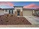 Charming single-story home featuring stone accents, neutral stucco, and a well-maintained landscaped yard at 17140 W Running Deer Trl, Surprise, AZ 85387
