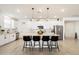 Stylish kitchen with white cabinets, a central island with seating, and stainless steel appliances at 17140 W Running Deer Trl, Surprise, AZ 85387