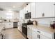 Bright kitchen featuring white cabinets, stainless steel appliances, and light countertops at 17140 W Running Deer Trl, Surprise, AZ 85387