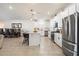 Modern kitchen showcasing white cabinetry, a large island with seating, and stainless steel appliances at 17140 W Running Deer Trl, Surprise, AZ 85387