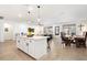Open floor plan with an island separating the kitchen from the dining and living room area at 17140 W Running Deer Trl, Surprise, AZ 85387
