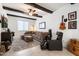 Cozy living room with dark wooden beams, a comfortable sectional, and unique decorative touches at 17140 W Running Deer Trl, Surprise, AZ 85387