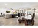 Open-concept living space with a large dining table and comfortable seating area at 17140 W Running Deer Trl, Surprise, AZ 85387