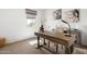 Bright office space with natural light, a stylish desk, and serene decor for a productive work environment at 17140 W Running Deer Trl, Surprise, AZ 85387