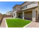 Backyard features covered patio, green turf, and low maintenance gravel landscaping at 1879 W 23Rd Ave, Apache Junction, AZ 85120