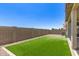 Backyard has a section of green turf grass bordered with gravel and a block wall at 1879 W 23Rd Ave, Apache Junction, AZ 85120