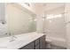 Bathroom features a modern vanity with framed mirror and shower-tub combination at 1879 W 23Rd Ave, Apache Junction, AZ 85120