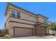 Two-story home featuring neutral stucco, brown trim, brick accents, and a 2-car garage, complemented by clean landscaping at 1879 W 23Rd Ave, Apache Junction, AZ 85120