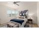 Comfortable main bedroom featuring a ceiling fan, large windows, and tasteful decor at 1879 W 23Rd Ave, Apache Junction, AZ 85120