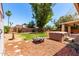 Spacious backyard with lush greenery, a fire pit, and an in-ground hot tub at 18805 N 49Th Dr, Glendale, AZ 85308