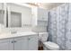 Clean bathroom featuring a vanity, mirror, toilet, and patterned shower curtain at 18805 N 49Th Dr, Glendale, AZ 85308