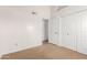 Neutral carpeted bedroom featuring a double door closet and access to bathroom at 18805 N 49Th Dr, Glendale, AZ 85308