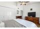 Bright bedroom featuring a ceiling fan, wood dresser, and closet with white doors at 18805 N 49Th Dr, Glendale, AZ 85308
