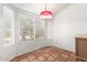 Bright dining area with tile flooring, a window, and a unique light fixture at 18805 N 49Th Dr, Glendale, AZ 85308