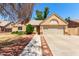 Well-maintained home with a two-car garage, desert landscaping, and a charming, inviting front entrance at 18805 N 49Th Dr, Glendale, AZ 85308
