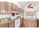 Bright kitchen featuring tile floors, ample cabinet space, granite countertops and a white range at 18805 N 49Th Dr, Glendale, AZ 85308
