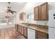 Bright kitchen featuring granite countertops, tile floors, stainless steel sink and white dishwasher and refrigerator at 18805 N 49Th Dr, Glendale, AZ 85308