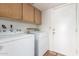 Functional laundry room with washer, dryer, and cabinets above at 18805 N 49Th Dr, Glendale, AZ 85308