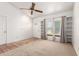 Well-lit living area features a vaulted ceiling, carpet flooring, and built in shelving at 18805 N 49Th Dr, Glendale, AZ 85308