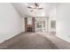 Large living room showcases a brick fireplace, carpet floors, ceiling fan and sliding doors at 18805 N 49Th Dr, Glendale, AZ 85308