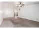 Expansive living area boasts carpet, tile flooring, a ceiling fan, and a view into another room at 18805 N 49Th Dr, Glendale, AZ 85308