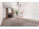 Spacious living area features carpet flooring, ceiling fan, and brick fireplace at 18805 N 49Th Dr, Glendale, AZ 85308