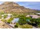 Overhead shot of a home nestled in a mountain landscape with a sport court at 22020 N Church Rd, Scottsdale, AZ 85255