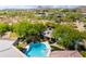 An aerial view of a backyard pool, spa and lush desert landscaping at 22020 N Church Rd, Scottsdale, AZ 85255