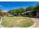 Expansive backyard with multi-sport game court, playground, and lush landscaping, perfect for outdoor enjoyment at 22020 N Church Rd, Scottsdale, AZ 85255
