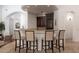 Interior bar area featuring dark wood cabinetry and seating for four at 22020 N Church Rd, Scottsdale, AZ 85255