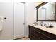 Stylish bathroom with white door, decorative mirror, and a single sink vanity at 22020 N Church Rd, Scottsdale, AZ 85255