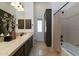 Bathroom featuring a single sink, dark wood cabinetry, and a shower-tub combination at 22020 N Church Rd, Scottsdale, AZ 85255