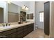 Spacious bathroom featuring double sinks, dark wood cabinetry, and ample counter space at 22020 N Church Rd, Scottsdale, AZ 85255