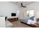 Cozy bedroom showcasing a comfortable bed, window views, and a modern ceiling fan at 22020 N Church Rd, Scottsdale, AZ 85255