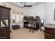 Bright bedroom with bunk beds, large window, and a ceiling fan for added comfort at 22020 N Church Rd, Scottsdale, AZ 85255