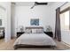 Stylish bedroom featuring a king bed with decorative pillows, dark nightstands, and high ceilings at 22020 N Church Rd, Scottsdale, AZ 85255
