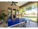 Inviting covered patio featuring a ping pong table and serene views of the well-manicured backyard at 22020 N Church Rd, Scottsdale, AZ 85255