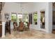 Bright dining area offers views of the backyard pool through expansive windows at 22020 N Church Rd, Scottsdale, AZ 85255