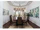 Elegant dining room with wood floors, stylish chandelier and views from the bay window at 22020 N Church Rd, Scottsdale, AZ 85255