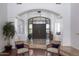 Grand foyer boasts arched entryway, elegant tile flooring, and stylish decor, creating a welcoming entrance at 22020 N Church Rd, Scottsdale, AZ 85255