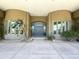 Elegant front entrance with double doors, palm trees, and sidelight windows at 22020 N Church Rd, Scottsdale, AZ 85255