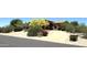 Beautiful home with meticulously landscaped front yard, mature trees, desert landscaping, and circular driveway at 22020 N Church Rd, Scottsdale, AZ 85255
