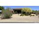 Lovely desert home featuring a fountain, mature landscaping, xeriscaping, and colorful accents at 22020 N Church Rd, Scottsdale, AZ 85255