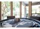 Well-lit game room with a poker table featuring a custom world map design and exterior views at 22020 N Church Rd, Scottsdale, AZ 85255