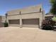 Spacious three-car garage with modern doors and an expansive driveway at 22020 N Church Rd, Scottsdale, AZ 85255
