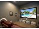 Private home theater featuring a large screen, comfortable seating, and theater decor at 22020 N Church Rd, Scottsdale, AZ 85255