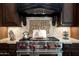 Gourmet kitchen boasts stainless steel appliances, custom range hood, and decorative tile backsplash at 22020 N Church Rd, Scottsdale, AZ 85255