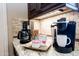 Coffee bar area showcasing coffee maker, Kuerig, granite countertops and designer tile backsplash at 22020 N Church Rd, Scottsdale, AZ 85255